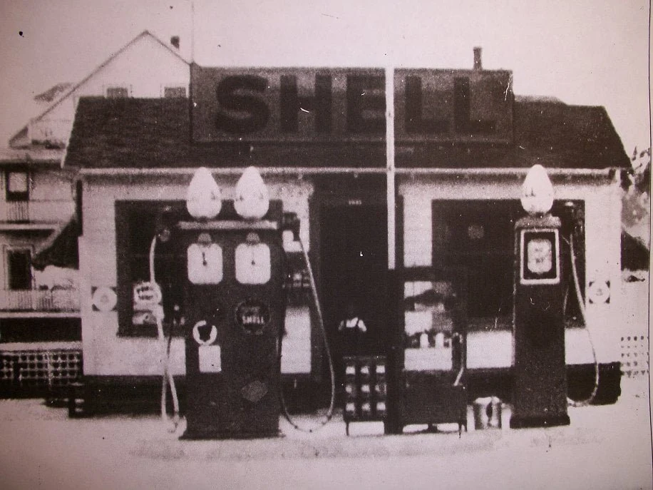 An archival photograph of Morin’s Service Station with its original Shell pumps