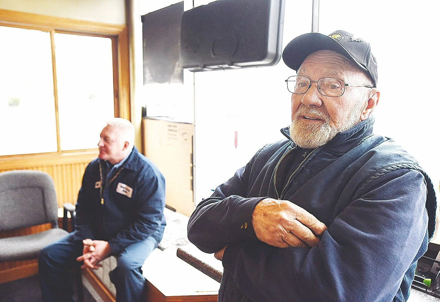 An archival photo of two people spending time inside Morin’s Service Station